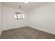 Bright bedroom with neutral carpeting and large window at 686 Ribbon Grass Ave, Las Vegas, NV 89183