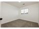 Bright bedroom with neutral carpeting and large window at 686 Ribbon Grass Ave, Las Vegas, NV 89183