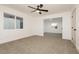 Spacious bedroom with ceiling fan and neutral carpeting at 686 Ribbon Grass Ave, Las Vegas, NV 89183