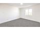 Well-lit bedroom featuring grey carpeting and a large window at 686 Ribbon Grass Ave, Las Vegas, NV 89183