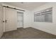 Bright bedroom with window, carpet, and a sliding barn door at 686 Ribbon Grass Ave, Las Vegas, NV 89183