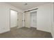 Bright bedroom with neutral carpeting and a sliding barn door closet at 686 Ribbon Grass Ave, Las Vegas, NV 89183