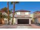 Two-story house with a dark brown garage door and palm trees at 686 Ribbon Grass Ave, Las Vegas, NV 89183