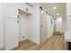 Hallway with barn door and wood-look floors at 686 Ribbon Grass Ave, Las Vegas, NV 89183