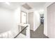 Upstairs hallway with neutral carpeting and access to bedrooms at 686 Ribbon Grass Ave, Las Vegas, NV 89183