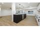 Modern kitchen with dark island and stainless steel appliances at 686 Ribbon Grass Ave, Las Vegas, NV 89183