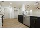 Modern kitchen with white cabinets and a dark island at 686 Ribbon Grass Ave, Las Vegas, NV 89183