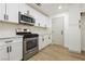 Modern kitchen with stainless steel appliances and white cabinets at 686 Ribbon Grass Ave, Las Vegas, NV 89183