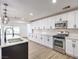 Modern kitchen with white cabinets, quartz countertops, and stainless steel appliances at 686 Ribbon Grass Ave, Las Vegas, NV 89183