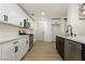 White kitchen with stainless steel appliances and wood-look floors at 686 Ribbon Grass Ave, Las Vegas, NV 89183