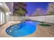 Inviting kidney shaped pool with a spa at night at 686 Ribbon Grass Ave, Las Vegas, NV 89183