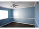 Simple bedroom with light blue walls and ceiling fan at 7563 Durham Hall Ave # 101, Las Vegas, NV 89130