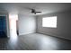 Living room featuring gray toned laminate wood flooring and ceiling fan at 7563 Durham Hall Ave # 101, Las Vegas, NV 89130