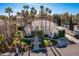 Stunning aerial view of a luxurious house with a manicured lawn and palm trees at 8109 Moonstone Cir, Las Vegas, NV 89128