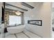 Relaxing bathroom with freestanding tub, fireplace, and large window at 8109 Moonstone Cir, Las Vegas, NV 89128