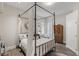 Elegant bedroom with a four-poster bed, hardwood floors, and ample closet space at 8109 Moonstone Cir, Las Vegas, NV 89128