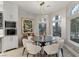 Bright breakfast nook with a round table and chairs near large windows at 8109 Moonstone Cir, Las Vegas, NV 89128