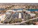 Scenic aerial view of neighborhood with community lake, shopping center, and parking lot at 8109 Moonstone Cir, Las Vegas, NV 89128