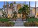 Elegant home entrance with a grand staircase and landscaping at 8109 Moonstone Cir, Las Vegas, NV 89128