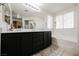 Bathroom with double vanity, soaking tub, and separate shower at 841 Glitter Glen Ct, Las Vegas, NV 89123