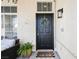 Welcoming front entry with black door, wreath, and potted plants at 841 Glitter Glen Ct, Las Vegas, NV 89123