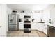 Modern kitchen featuring stainless steel appliances and white cabinetry at 841 Glitter Glen Ct, Las Vegas, NV 89123