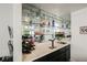 Wet bar with mirrored backsplash and ample storage at 841 Glitter Glen Ct, Las Vegas, NV 89123