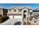 Two-story house with three-car garage and landscaped yard at 8508 Vivid Violet Ave, Las Vegas, NV 89143