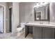 Clean bathroom with gray vanity and a linen cabinet at 900 Heavenly Hills Ct # 217, Las Vegas, NV 89145