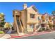 Two-story building exterior with Spanish tile roofing and landscaping at 900 Heavenly Hills Ct # 217, Las Vegas, NV 89145