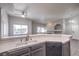 Modern kitchen featuring a double sink, dishwasher, and gray cabinets at 900 Heavenly Hills Ct # 217, Las Vegas, NV 89145