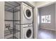 Laundry room with stackable washer/dryer and storage shelves at 900 Heavenly Hills Ct # 217, Las Vegas, NV 89145