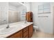 Bathroom with double vanity and wood cabinets at 10929 Mount Royal Ave, Las Vegas, NV 89144