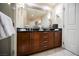 Bathroom vanity with double sinks, dark wood cabinets, and white doors at 135 E Harmon Ave # 407, Las Vegas, NV 89109