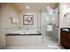 Spacious bathroom features a tub with jet and glass shower with sleek fixtures, creating a luxurious and relaxing space at 135 E Harmon Ave # 407, Las Vegas, NV 89109