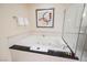 Elegant bathroom with a large soaking tub and black countertop at 135 E Harmon Ave # 407, Las Vegas, NV 89109