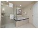 Hotel bathroom featuring a bathtub, a glass-enclosed shower, and modern fixtures at 135 E Harmon Ave # 407, Las Vegas, NV 89109