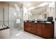 Modern bathroom featuring glass enclosed shower, bathtub, and double sink vanity at 135 E Harmon Ave # 407, Las Vegas, NV 89109