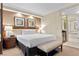 Hotel bedroom featuring a king-size bed with a bench, nightstands, lamps, and artwork for a cozy ambiance at 135 E Harmon Ave # 407, Las Vegas, NV 89109