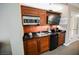 Functional kitchenette includes microwave, black countertop with sink, and fridge, optimizing space and convenience at 135 E Harmon Ave # 407, Las Vegas, NV 89109