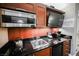 The kitchenette includes microwave, sink, mini-fridge, and a flat-screen TV, ideal for simple meals and entertainment at 135 E Harmon Ave # 407, Las Vegas, NV 89109