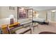 Hotel living room area featuring a sofa, chairs, coffee table, desk, and a view of the bedroom at 135 E Harmon Ave # 407, Las Vegas, NV 89109