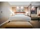 Hotel suite with a king bed, bench, and a partial view into the living room at 135 E Harmon Ave # 407, Las Vegas, NV 89109