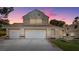 Two-story house with a three-car garage and landscaped yard at 2645 Douglas Cir, Henderson, NV 89074