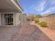 Covered patio and cozy backyard featuring desert landscaping, perfect for outdoor living at 3408 Isle Dr, Las Vegas, NV 89141