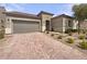 Inviting single-story home with a two-car garage, tile roof and manicured front yard at 3408 Isle Dr, Las Vegas, NV 89141