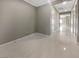 Bright hallway with tile flooring and neutral paint, leading to other rooms in the home at 3408 Isle Dr, Las Vegas, NV 89141