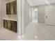 Hallway with stylish cabinetry, white tile flooring and easy access to the main entrance at 3408 Isle Dr, Las Vegas, NV 89141