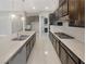 Modern kitchen featuring dark cabinets, quartz countertops, stainless steel appliances, and pendant lighting at 3408 Isle Dr, Las Vegas, NV 89141