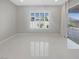 Bright living room featuring tile floors, a window with shutters, and a sliding glass door at 3408 Isle Dr, Las Vegas, NV 89141